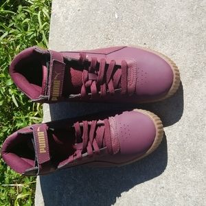 Burgundy Puma high top sneakers.